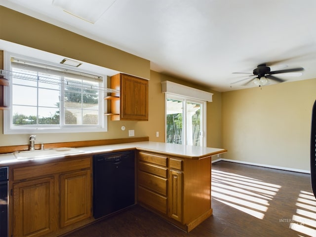 kitchen with sink, dark hardwood / wood-style flooring, black dishwasher, kitchen peninsula, and ceiling fan