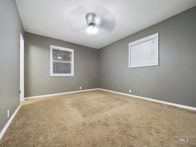 carpeted empty room featuring ceiling fan