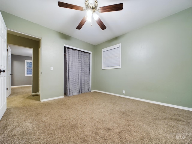 unfurnished bedroom featuring a closet, ceiling fan, and carpet flooring