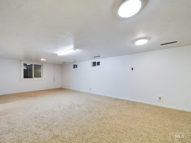 unfurnished room with carpet floors and a textured ceiling