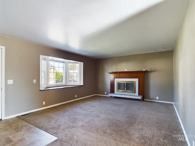 unfurnished living room with carpet floors