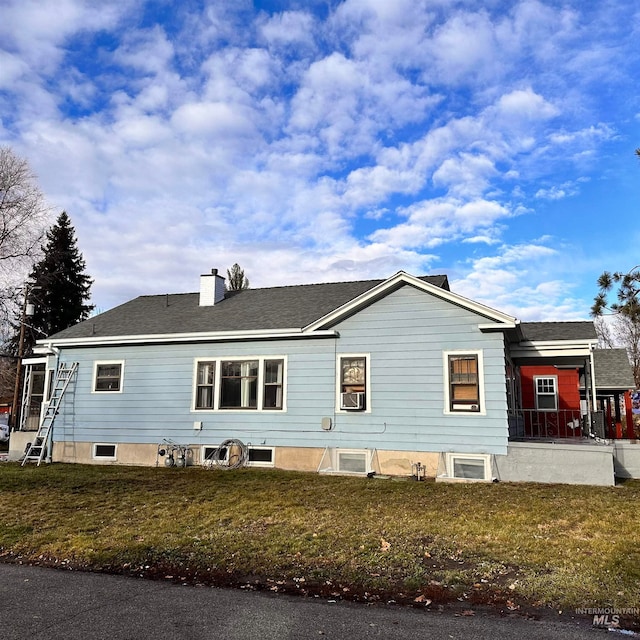 view of side of property with a lawn