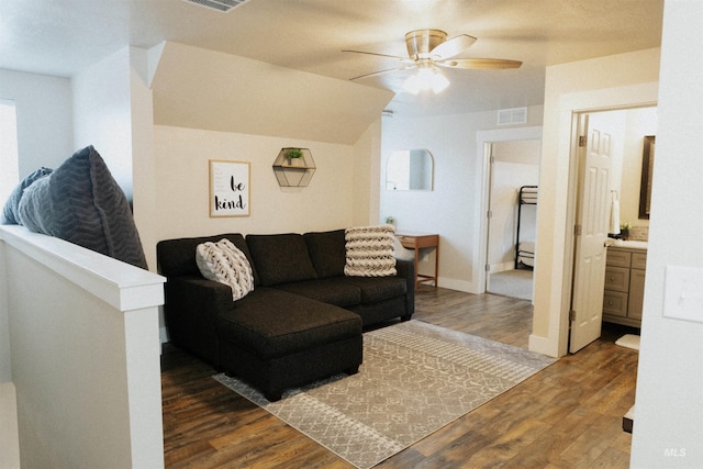 living room with dark wood-type flooring and ceiling fan