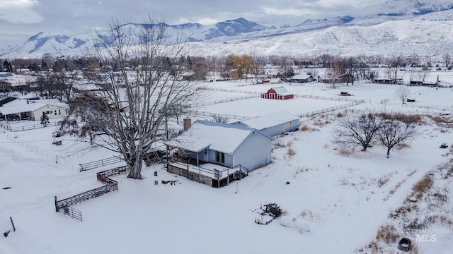 snowy aerial view with a mountain view