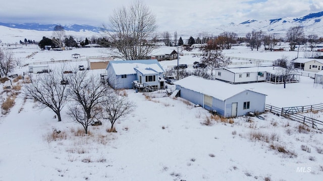 snowy aerial view with a mountain view