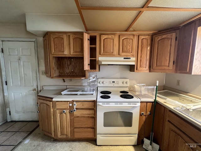 kitchen with brown cabinetry, light countertops, electric stove, and under cabinet range hood