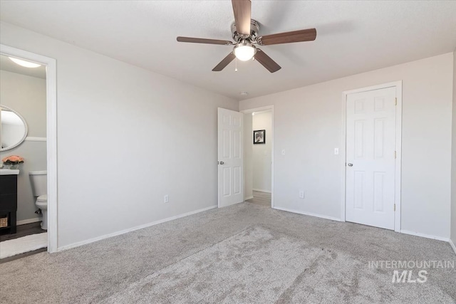 unfurnished bedroom with ensuite bathroom, carpet floors, ceiling fan, and baseboards