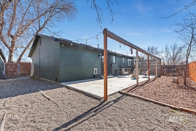 rear view of property with a patio and a fenced backyard