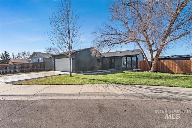 single story home featuring an attached garage, fence, concrete driveway, and a front yard