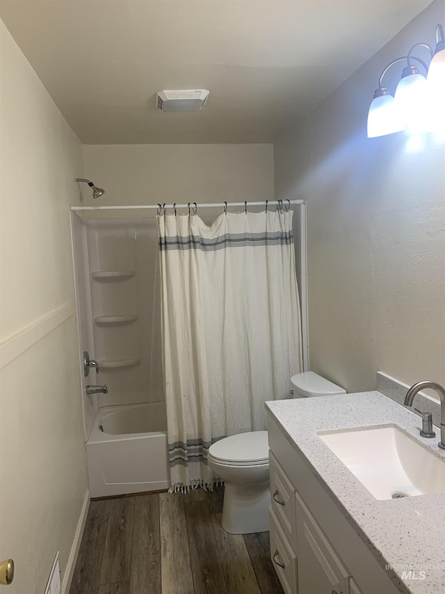 full bathroom with toilet, vanity, shower / bath combination with curtain, and hardwood / wood-style floors