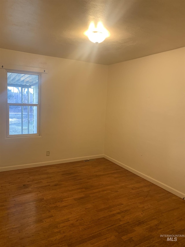 empty room featuring dark hardwood / wood-style floors