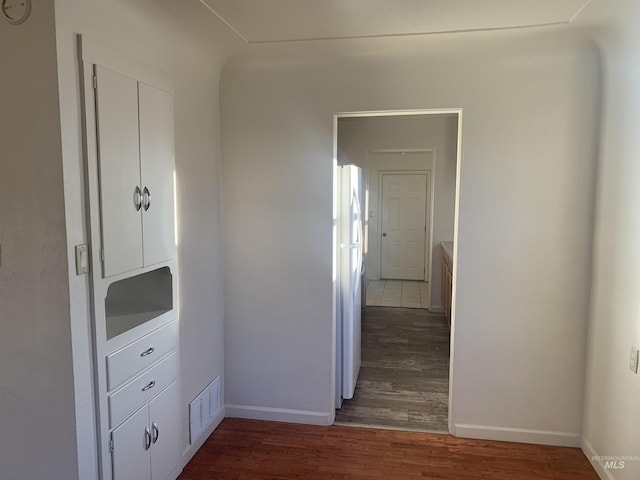 corridor with dark wood-type flooring