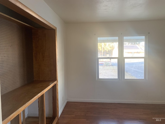 empty room featuring dark wood-type flooring