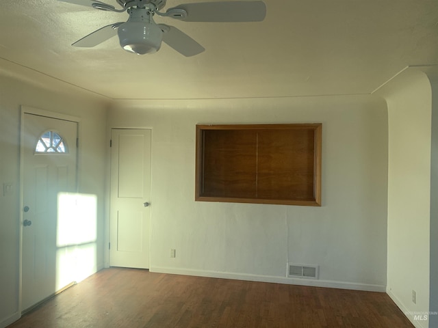 empty room with ceiling fan and hardwood / wood-style flooring