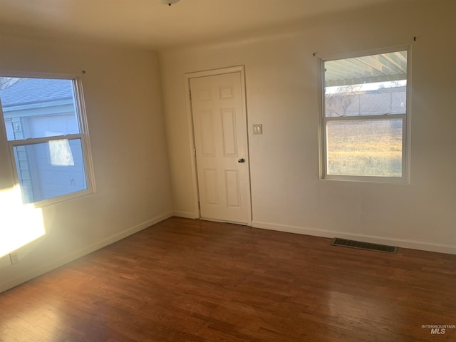 empty room with dark hardwood / wood-style floors