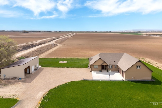 birds eye view of property with a rural view