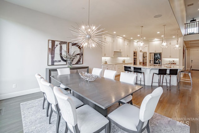 5946 E Barber Dr, Boise, ID 83716 - dining space featuring a chandelier, wood finished floors, baseboards, and recessed lighting