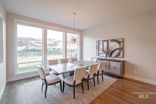 5946 E Barber Dr, Boise, ID 83716 - dining area featuring visible vents, a wealth of natural light, wood finished floors, and baseboards