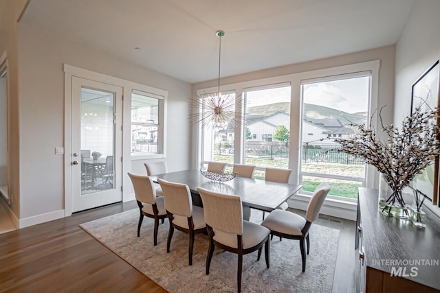 5946 E Barber Dr, Boise, ID 83716 - dining space with baseboards, a notable chandelier, and dark wood finished floors