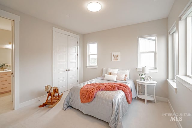 5946 E Barber Dr, Boise, ID 83716 - carpeted bedroom featuring a closet, baseboards, and connected bathroom