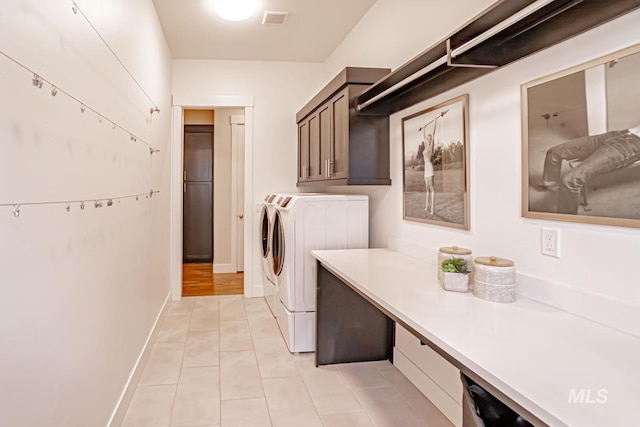 5946 E Barber Dr, Boise, ID 83716 - clothes washing area featuring light tile patterned floors, visible vents, washer and dryer, baseboards, and cabinet space