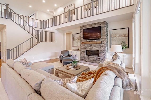 5946 E Barber Dr, Boise, ID 83716 - living area featuring baseboards, a fireplace, recessed lighting, stairway, and a towering ceiling