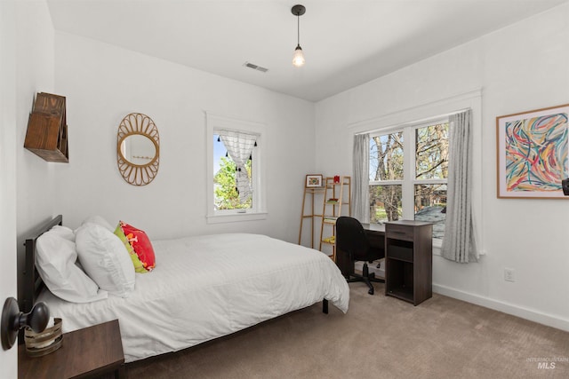 bedroom with carpet floors, baseboards, and visible vents