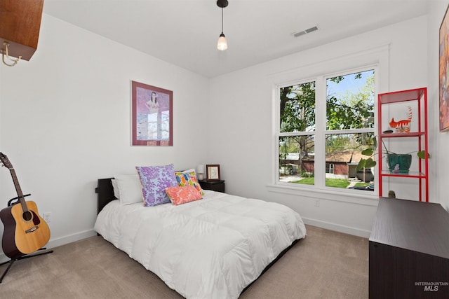 carpeted bedroom featuring baseboards and visible vents