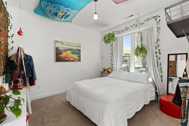 bedroom with carpet floors, baseboards, and visible vents