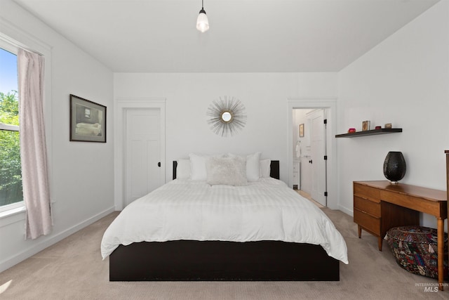 bedroom featuring baseboards and light carpet