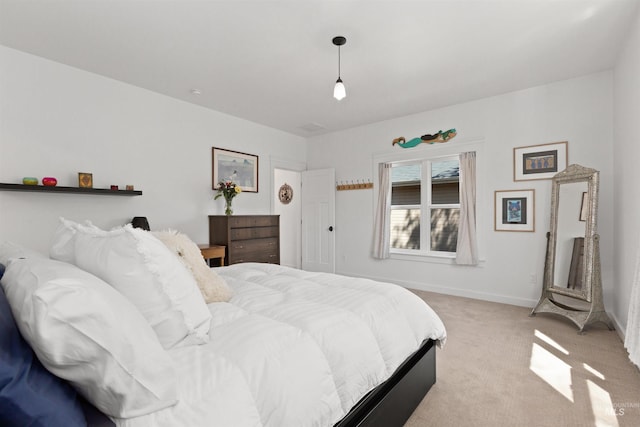 bedroom featuring baseboards and light colored carpet