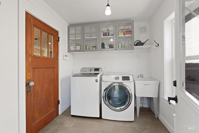 laundry area with separate washer and dryer, laundry area, and baseboards