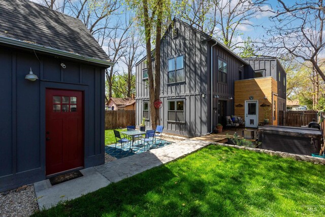 view of yard featuring a patio, a fenced backyard, and an outdoor structure