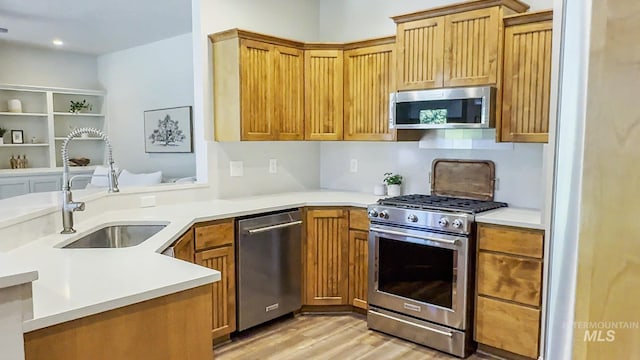 104 E Stonewater, Eagle, ID 83616 - kitchen with stainless steel appliances, light wood finished floors, light countertops, a peninsula, and recessed lighting