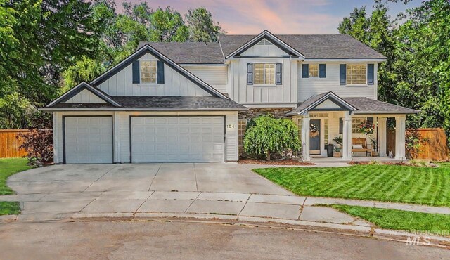 104 E Stonewater, Eagle, ID 83616 - view of front of home featuring concrete driveway, a garage, board and batten siding, roof with shingles, and covered porch