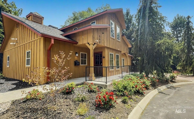 104 E Stonewater, Eagle, ID 83616 - chalet / cabin featuring board and batten siding, covered porch, and roof with shingles
