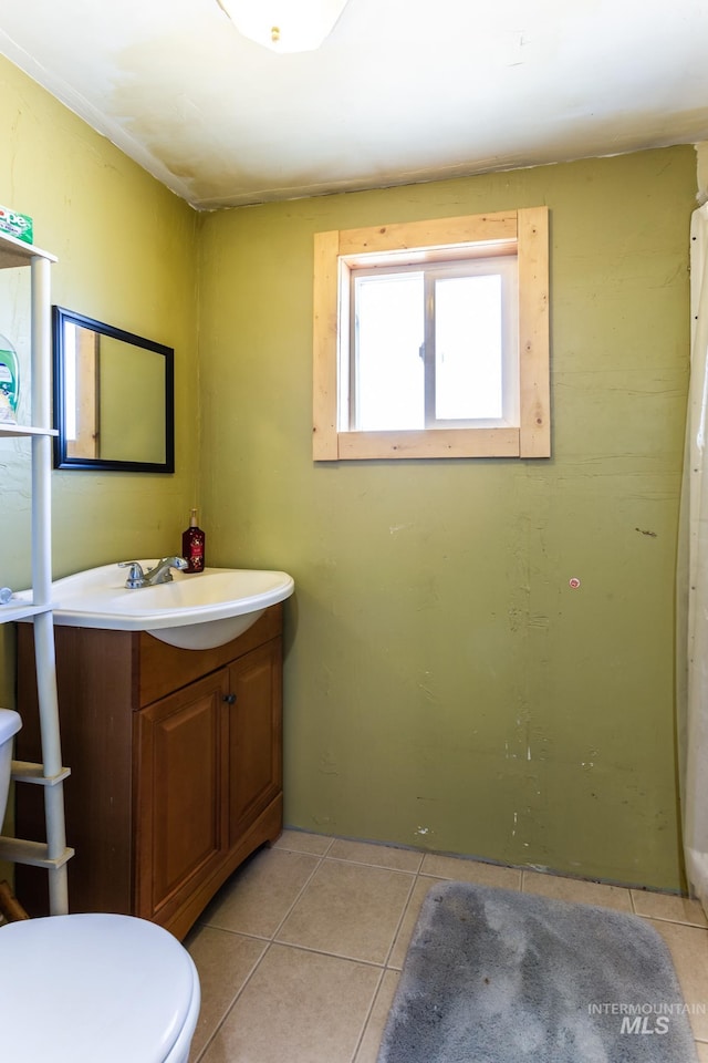 bathroom with vanity, toilet, and tile patterned flooring