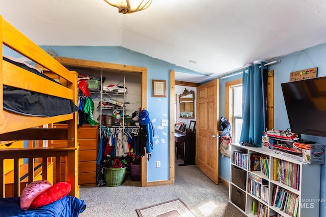 bedroom with carpet flooring and vaulted ceiling