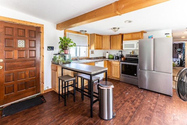 kitchen featuring appliances with stainless steel finishes, dark hardwood / wood-style floors, beam ceiling, and sink