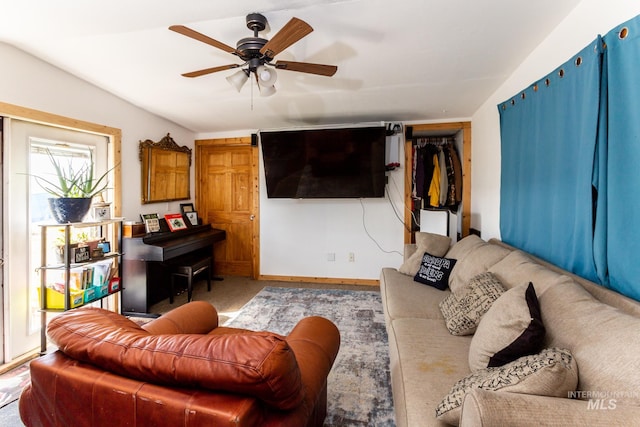 living room featuring lofted ceiling, carpet, and ceiling fan