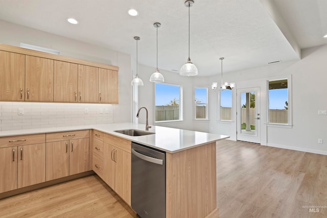 kitchen with light brown cabinets, kitchen peninsula, stainless steel dishwasher, light hardwood / wood-style floors, and sink