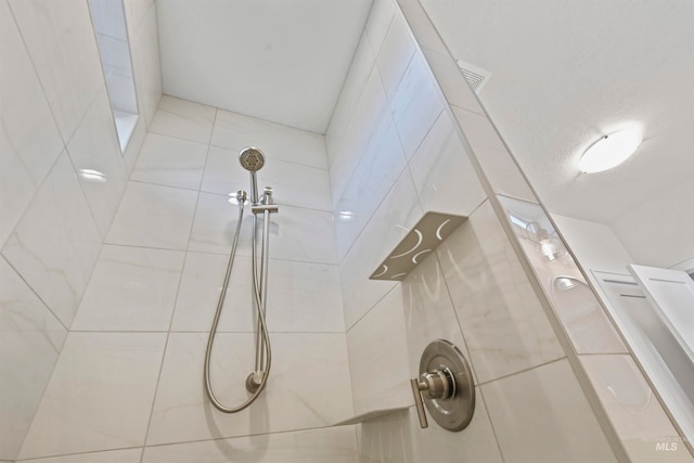 bathroom with tiled shower