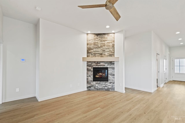 unfurnished living room with light hardwood / wood-style flooring, a fireplace, and ceiling fan