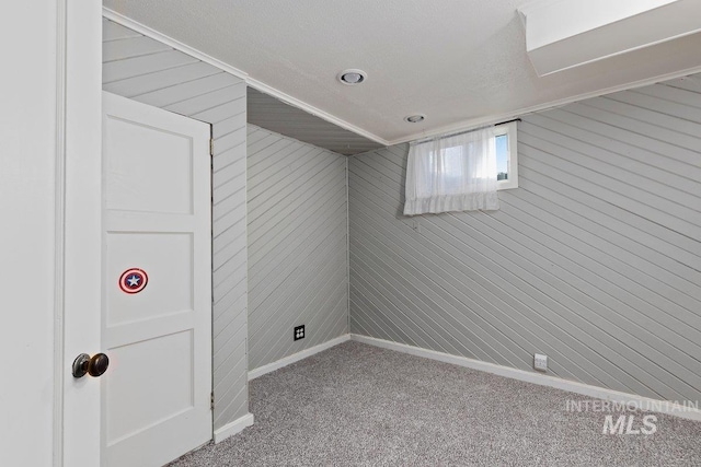 176 Taylor St, Twin Falls, ID 83301 - below grade area with carpet floors, wooden walls, baseboards, and crown molding