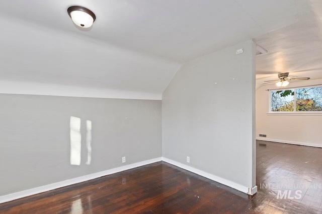 bonus room featuring dark hardwood / wood-style flooring, lofted ceiling, and ceiling fan