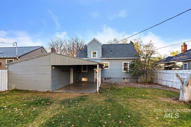 rear view of property featuring a patio area and a yard