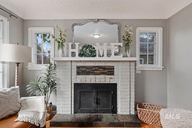 176 Taylor St, Twin Falls, ID 83301 - detailed view of a fireplace, a textured ceiling, and wood finished floors