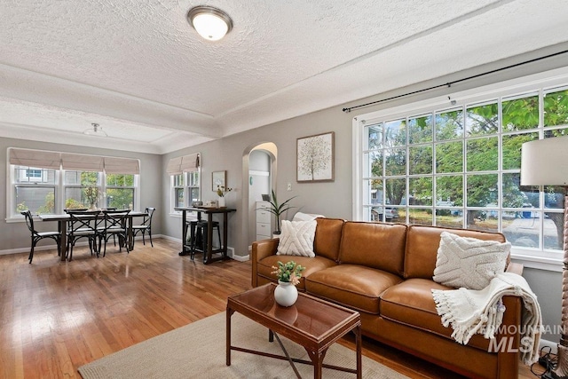 living room with wood-type flooring and a textured ceiling