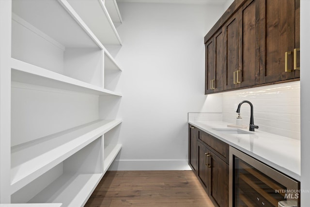 interior space with wine cooler and sink