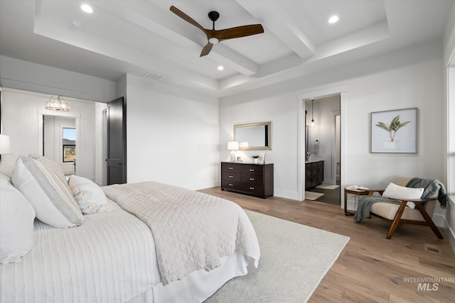 bedroom featuring beam ceiling, ensuite bathroom, ceiling fan, and light hardwood / wood-style floors